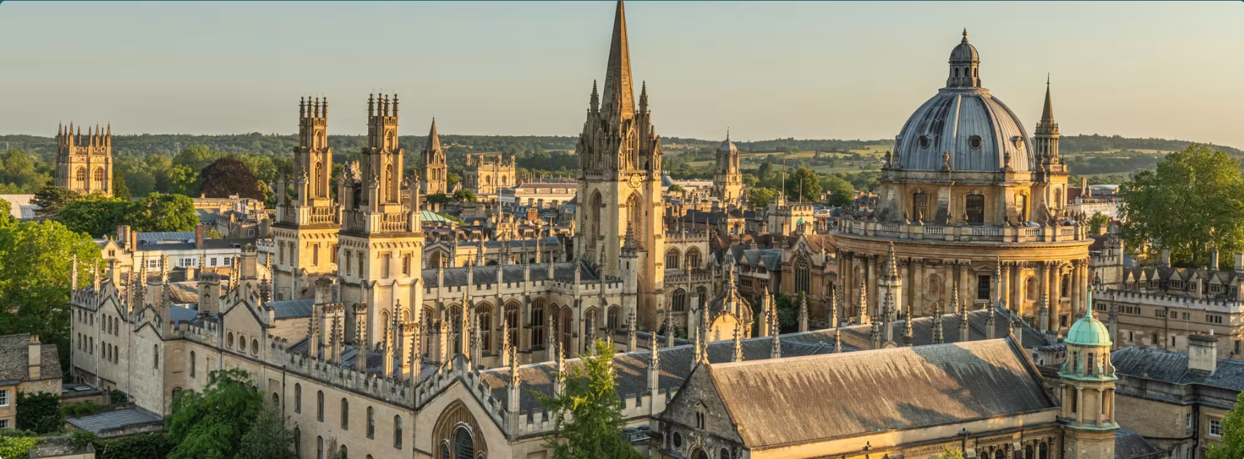 Aerial view of the Oxford skyline at sunset, with the Radcliffe Camera and historic college spires